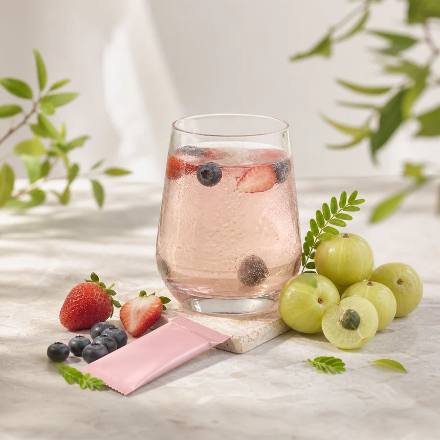 Amla fruit and a wellness drink with berries